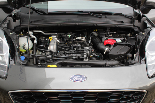 Ford Puma 1.0-125pk EcoBoost Hybrid Titanium. Garantie t/m 21-05-2027 ! Slechts 14.750km ! Volautm. airco, metallic lak, stoel-, stuur- en voorraamverwarming, navigatie, telefoonvoorbereiding, elektrische achterklep, cruise cntrl, keyless entry / keyless go etc.