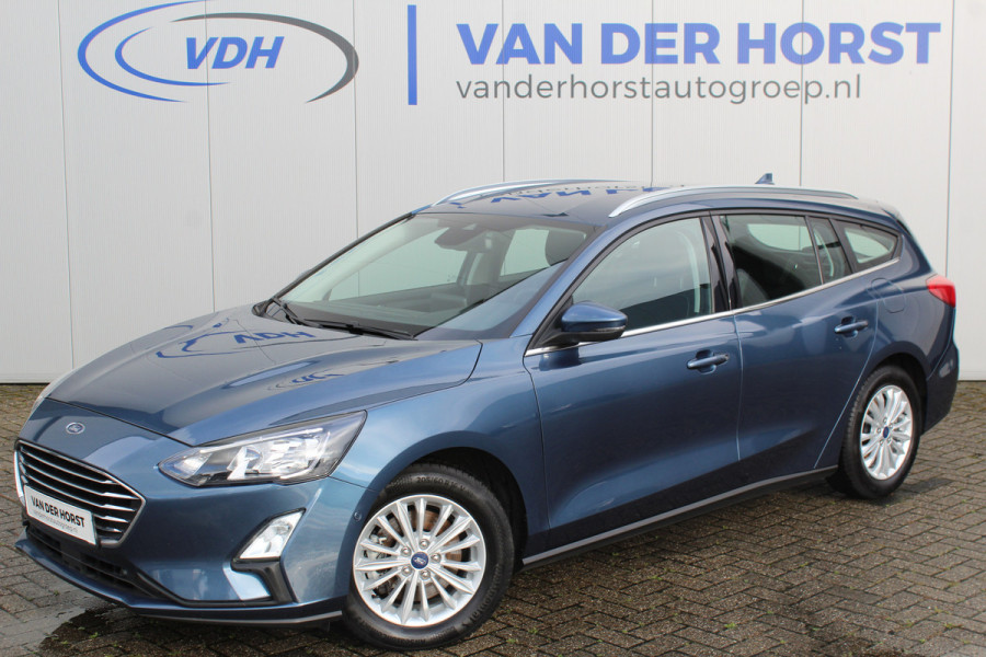 Ford FOCUS Wagon 1.0-125pk EcoBoost Mild-hybrid Titanium. Mooie, ruime, luxe en comfortabele Ford Focus wagon. Volautm. airco dual, camera, stoel-, stuur- en voorraamverw., easy entry/easy go, cruise control, Isofix, side- en lane assist, parkeersensoren v+a, LM wielen etc.