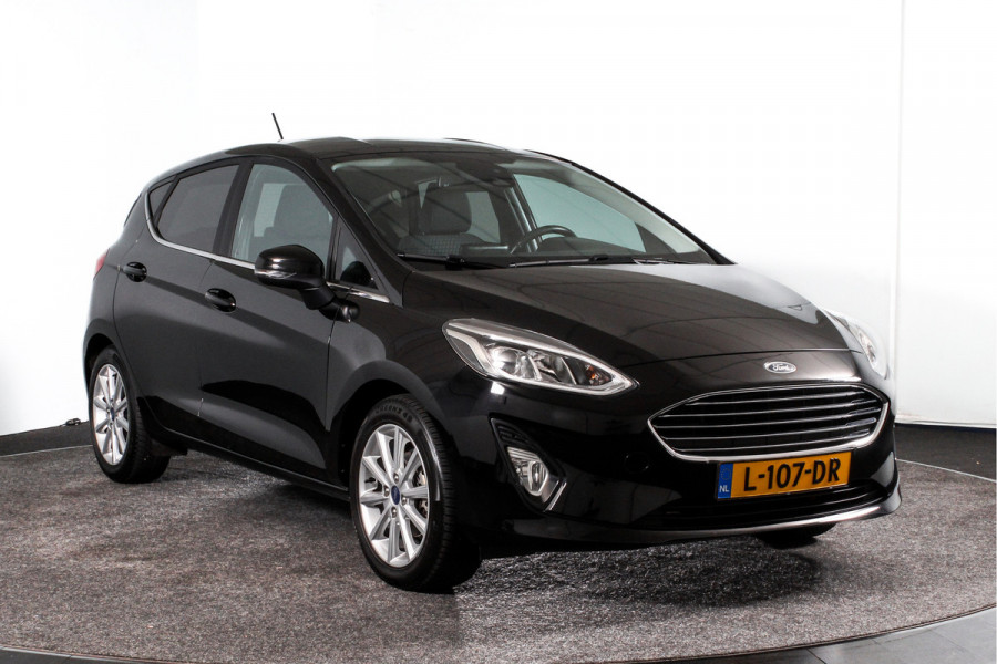 Ford Fiesta 1.0 EcoBoost Titanium | Cruise | Stoel + Stuurverwarming | PDC | App.Connect | DAB | Auto.Airco | Trekhaak | LM 16" |