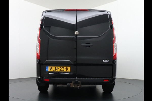 Ford Transit Custom 2.0D 130PK L1H1 3pers. Airco PDC-a+v Trekhaak Cruise-Controle voorruit verwarmbaar Betonplex Schuifdeur-r Tussenwand voorruit ve Adaptieve bochtverl. Projector-koplamp mistlampen regen-/lichtsensor Dieselroetfilter Supervergrendeling EURO 6 385Nm 2.500kg Trekvermogen!