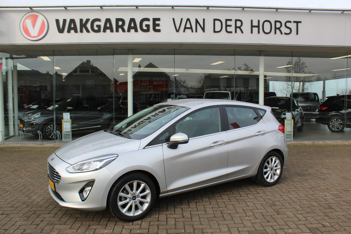 Ford Fiesta 1.0-100pk EcoBoost Titanium 5drs. Uiterst nette, luxe en zuinige Ford Fiesta. Voalautm. airco, Cruise control, Navigatie, LM wielen, Metallic lak, Parkeersensoren achter, Telefoonvoorb., Lane assist etc.