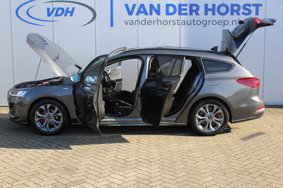 Ford FOCUS Wagon 1.0-125pk EcoBoost ST-Line X. Geweldig mooie, luxe en sportieve Focus wagon ! Slechts 12.000km ! Autm. airco, stoel-, stuur- en voorraamverw., ergonomische stoelen, adaptieve cruise cntrl, side- en lane assist, elektr. panodak, B&O soundsyst., etc.