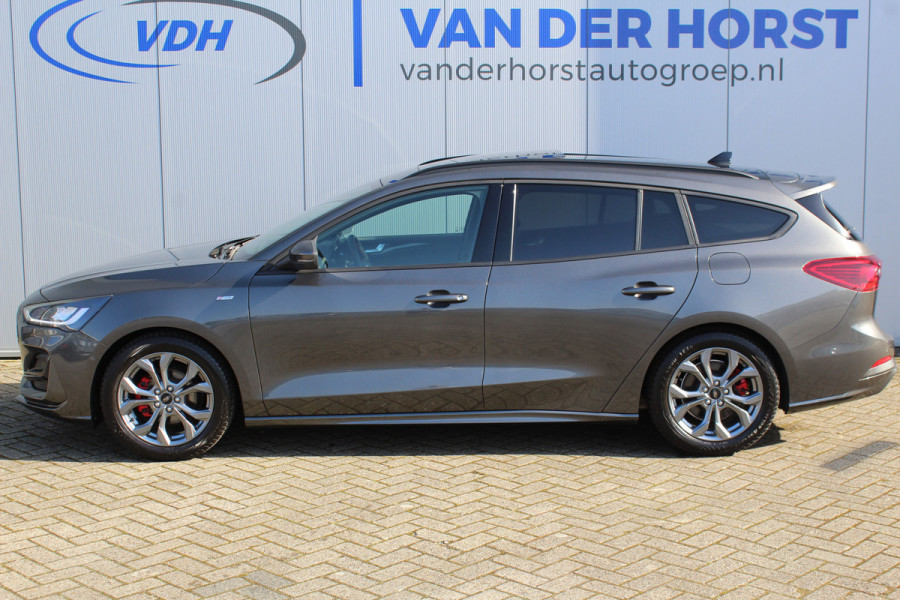 Ford FOCUS Wagon 1.0-125pk EcoBoost ST-Line X. Geweldig mooie, luxe en sportieve Focus wagon ! Slechts 12.000km ! Autm. airco, stoel-, stuur- en voorraamverw., ergonomische stoelen, adaptieve cruise cntrl, side- en lane assist, elektr. panodak, B&O soundsyst., etc.