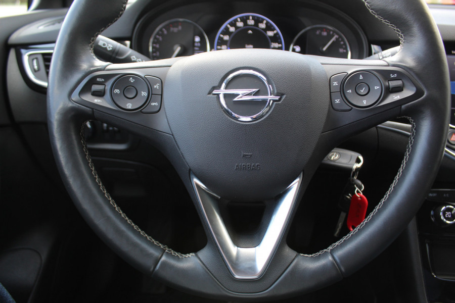 Opel Astra Sports Tourer 1.2-110pk Elegance. Ruime, sportieve, luxe en degelijke gezinswagen ! Autm. airco, stoel- en stuurwiel verw., LED verl., camera, parkeersens. v+a, metallic lak, LM wielen, Apple carplay/Android auto, navigatie, telefoonvoorb., cruise cntrl etc.