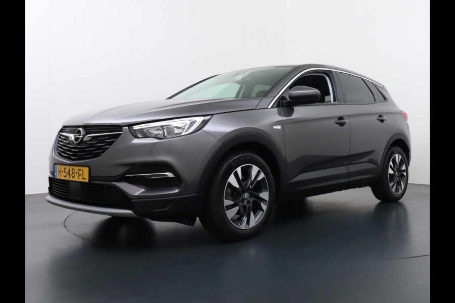 Opel Grandland X T131PK Autom. AGR-Comfort Stoelen Apple Carplay Android Auto Navi Ecc Elek.Achterklep Stuur/Stoelverwarming Cruise Control Pdc K Regen/Lichtsensor Dodehoeksensor Rijstrooksensor Verkeersbordlezer Winterpakket DAB+ Lmv 18" 1.2 Turbo 1e Eigenaar
