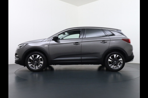 Opel Grandland X T131PK Autom. AGR-Comfort Stoelen Apple Carplay Android Auto Navi Ecc Elek.Achterklep Stuur/Stoelverwarming Cruise Control Pdc K Regen/Lichtsensor Dodehoeksensor Rijstrooksensor Verkeersbordlezer Winterpakket DAB+ Lmv 18" 1.2 Turbo 1e Eigenaar