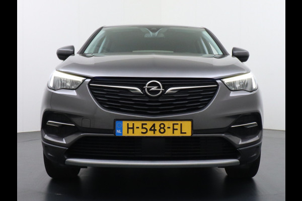 Opel Grandland X T131PK Autom. AGR-Comfort Stoelen Apple Carplay Android Auto Navi Ecc Elek.Achterklep Stuur/Stoelverwarming Cruise Control Pdc K Regen/Lichtsensor Dodehoeksensor Rijstrooksensor Verkeersbordlezer Winterpakket DAB+ Lmv 18" 1.2 Turbo 1e Eigenaar