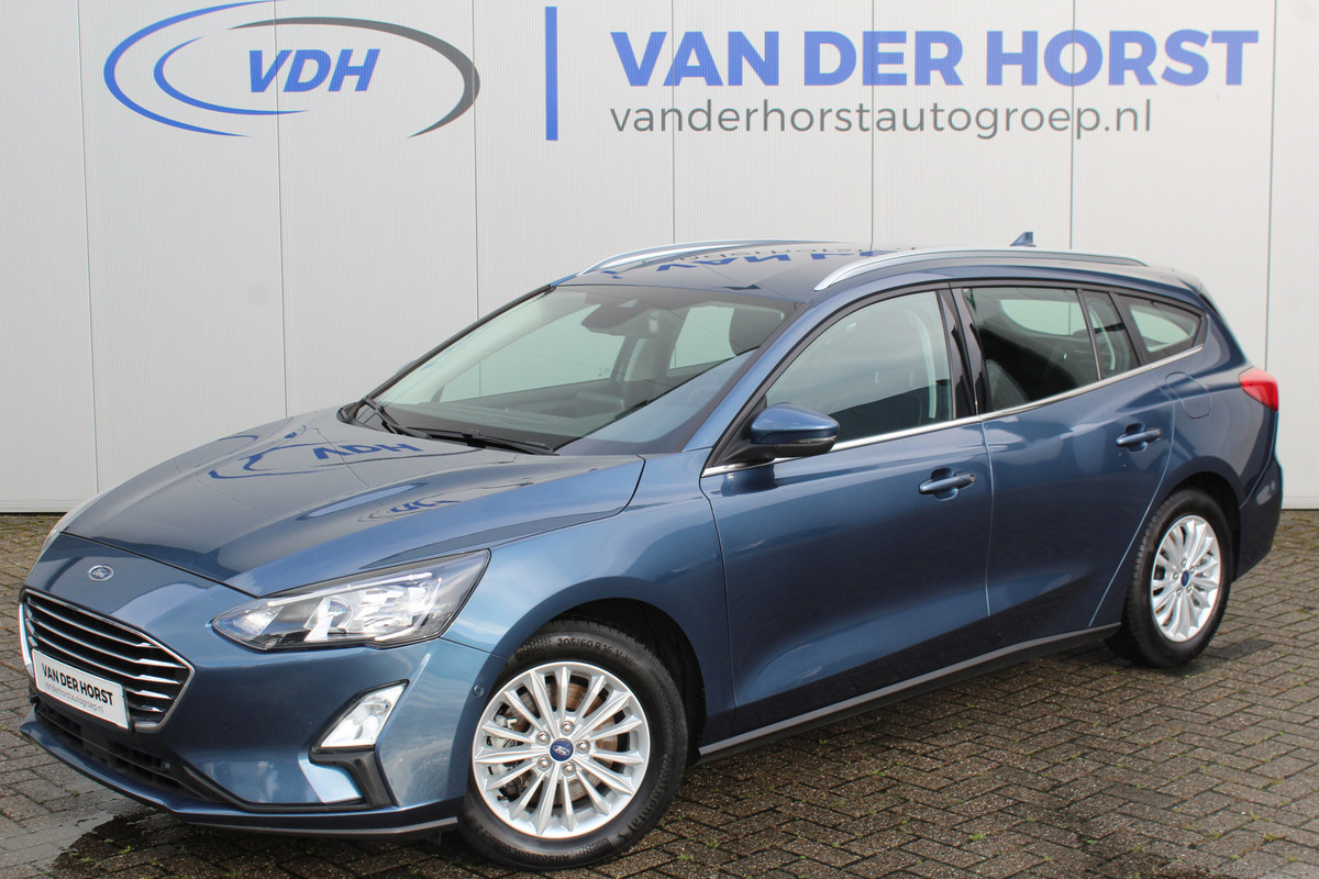 Ford FOCUS Wagon 1.0-125pk EcoBoost Mild-hybrid Titanium. Mooie, ruime, luxe en comfortabele Ford Focus wagon. Volautm. airco dual, camera, stoel-, stuur- en voorraamverw., easy entry/easy go, cruise control, Isofix, side- en lane assist, parkeersensoren v+a, LM wielen etc. Ford FOCUS Wagon 1.0-125pk EcoBoost Mild-hybrid Titanium. Mooie, ruime, luxe en comfortabele Ford Focus wagon. Volautm. airco dual, camera, stoel-, stuur- en voorraamverw., easy entry/easy go, cruise control, Isofix, side- en lane assist, parkeersensoren v+a, LM wielen etc.