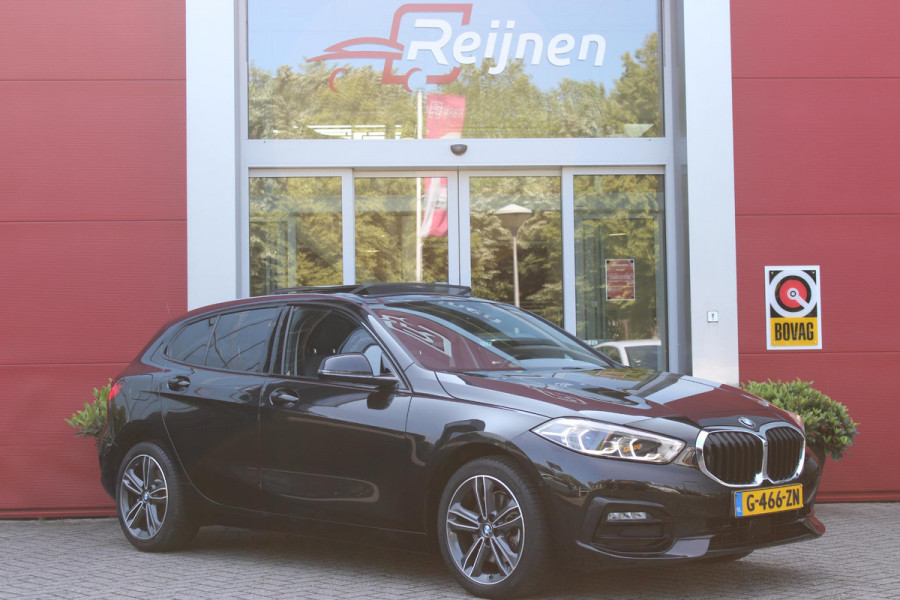 BMW 1-serie 118i 140PK AUTOMAAT EXECUTIVE EDITION | PANORAMISCH SCHUIF/KANTELKDAK | AFNEEMBARE TREKHAAK | DRAADLOZE TELEFOONLADER | DRAADLOZE APPLE CARPLAY/ANDROID AUTO | NAVIGATIE | ACHTERUITRIJ CAMERA | PARKEERSENSOREN VOOR EN ACHTER | CRUISE CONTROL | FULL LED KOPLAMPEN | CLIMATE CONTROL | ALL SEASON BANDEN | 17" LICHTMETALEN VELGEN |