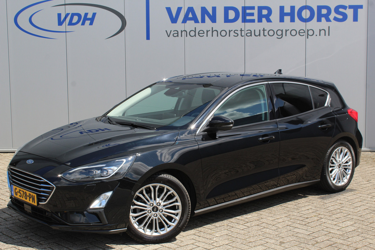 Ford Focus 1.0-125pk EcoBoost Titanium. Erg nette, luxe en goed onderhouden Ford Focus. Volautm. airco dual, stoel-, stuur- en voorraamverw., trekhaak, Xenon verl., LM wielen, navigatie, telefoonvoorb., adaptieve cruise cntrl, keyless entry/keyless go etc, etc. Ford Focus 1.0-125pk EcoBoost Titanium. Erg nette, luxe en goed onderhouden Ford Focus. Volautm. airco dual, stoel-, stuur- en voorraamverw., trekhaak, Xenon verl., LM wielen, navigatie, telefoonvoorb., adaptieve cruise cntrl, keyless entry/keyless go etc, etc.