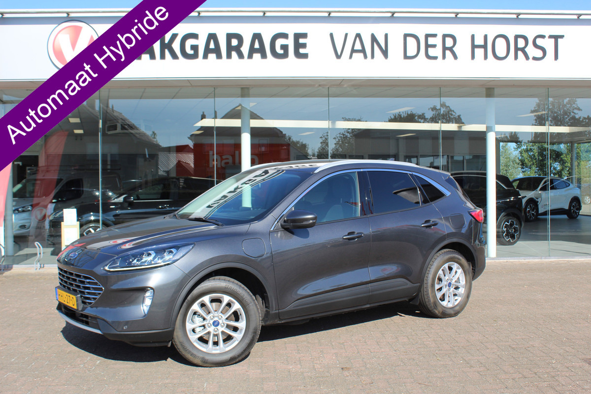 Ford Kuga 2.5-225pk PHEV Titanium X Plug-In Hybrid. Fabr. garantie t/m 07-04-2028 ! Slechts 10.000km ! Autm. airco dual, stoel-, stuur- en voorraamverw., LED verl., B&O soundsyst., metallic lak, cruise control, camera, LM wielen, elektr. achterklep en best. stoel etc.