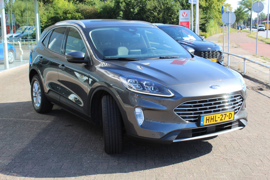Ford Kuga 2.5-225pk PHEV Titanium X Plug-In Hybrid. Fabr. garantie t/m 07-04-2028 ! Slechts 10.000km ! Autm. airco dual, stoel-, stuur- en voorraamverw., LED verl., B&O soundsyst., metallic lak, cruise control, camera, LM wielen, elektr. achterklep en best. stoel etc.