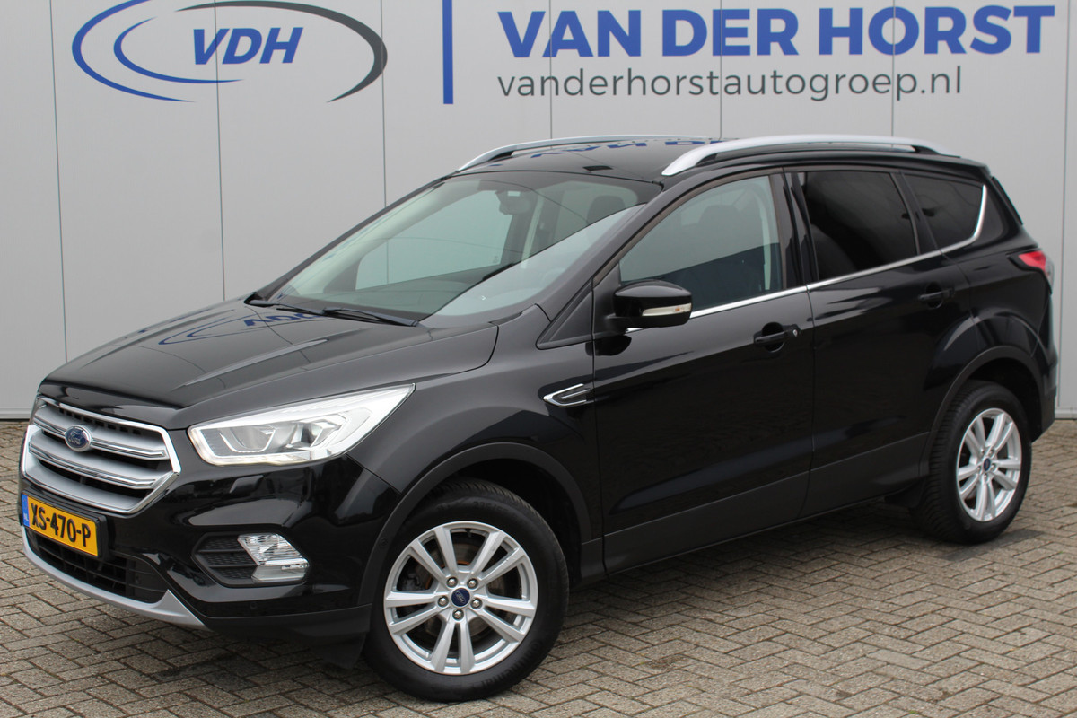 Ford Kuga 1.5-150pk EcoBoost Titanium. Trekgewicht 2.000kg ! Autm. airco dual, stoel-, stuur- en voorraamverwarming, cruise control, telefoonvoorb., navigatie, Sony soundsyst., LM wielen, trekhaak, privacy glass, All Season banden etc. Ford Kuga 1.5-150pk EcoBoost Titanium. Trekgewicht 2.000kg ! Autm. airco dual, stoel-, stuur- en voorraamverwarming, cruise control, telefoonvoorb., navigatie, Sony soundsyst., LM wielen, trekhaak, privacy glass, All Season banden etc.