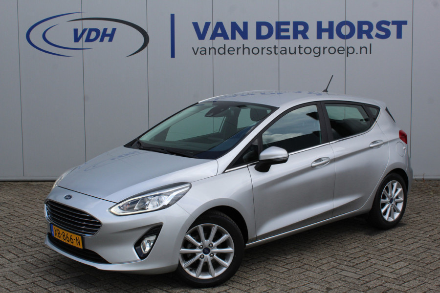 Ford Fiesta 1.0-100pk EcoBoost Titanium 5drs. Uiterst nette, luxe en zuinige Ford Fiesta. Voalautm. airco, Cruise control, Navigatie, LM wielen, Metallic lak, Parkeersensoren achter, Telefoonvoorb., Lane assist etc.