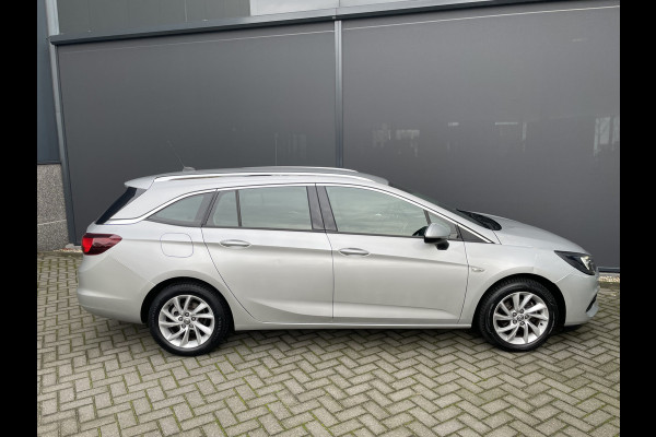 Opel Astra Sports Tourer 1.2 Business Elegance Airco - Cruise control - Parkeersensoren voor en achter - Achteruitrijcamera - Navigatie - Bluetooth - Keyless start and entry - Start/stop systeem - Stuur leder - Stuur multifunctioneel