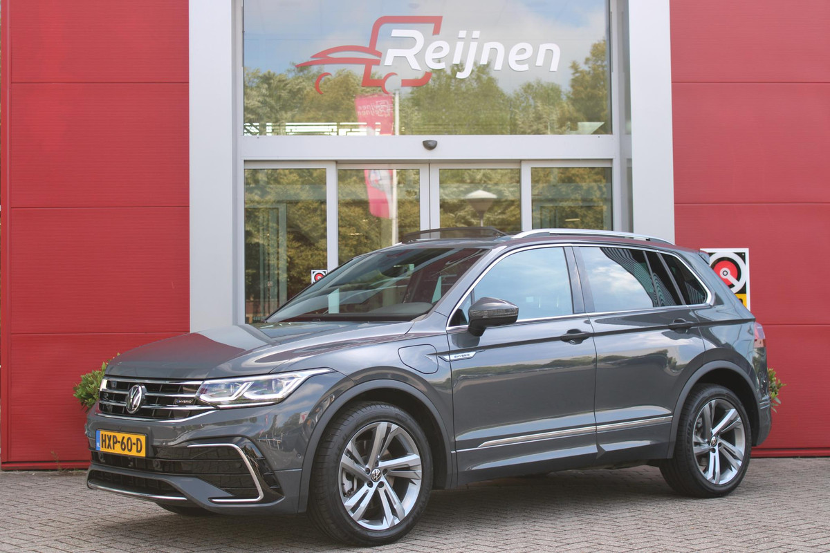 Volkswagen Tiguan 1.4 TSI 245PK eHybrid R-LINE BUSINESS + | BEKLEDING LEDER VIENNA | PANORAMISCH SCHUIF/KANTEL DAK | ELEKTRISCH WEGKLAPENBARE TREKHAAK | R-LINE INTERIEUR/EXTERIEUR | VERWARMBARE VOORSTOELEN/STUUR | ELEKTRISCH BEDIENBARE VOORSTOELEN MET GEHEUGEN FUNCTIE | AKOESTISCH GLAS GETINT | KEYLESS ACCESS/START | ELEKTRISCH BEDIENABRE ACHTERKLEP | DAKSPOILER R-LINE | SFEER VERLICHTING | RIJASSISTENT PAKKET O.A. LANE ASSIST EN ADAPTIVE CRUISE CONTROL EN DODEHOEK DETECTIE | NAVIGATIE | APPLE CARPLAY/ANDROID AUTO | DAB+ RADIO | LED MATRIX KOPLAMPEN (IQ LIGHT) | DRAADLOZE TELEFOONLADER