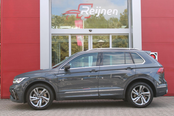 Volkswagen Tiguan 1.4 TSI 245PK eHybrid R-LINE BUSINESS + | BEKLEDING LEDER VIENNA | PANORAMISCH SCHUIF/KANTEL DAK | ELEKTRISCH WEGKLAPENBARE TREKHAAK | R-LINE INTERIEUR/EXTERIEUR | VERWARMBARE VOORSTOELEN/STUUR | ELEKTRISCH BEDIENBARE VOORSTOELEN MET GEHEUGEN FUNCTIE | AKOESTISCH GLAS GETINT | KEYLESS ACCESS/START | ELEKTRISCH BEDIENABRE ACHTERKLEP | DAKSPOILER R-LINE | SFEER VERLICHTING | RIJASSISTENT PAKKET O.A. LANE ASSIST EN ADAPTIVE CRUISE CONTROL EN DODEHOEK DETECTIE | NAVIGATIE | APPLE CARPLAY/ANDROID AUTO | DAB+ RADIO | LED MATRIX KOPLAMPEN (IQ LIGHT) | DRAADLOZE TELEFOONLADER