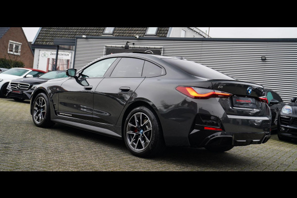 BMW i4 M50 High Executive 84 kWh | BTW | 360 Camera | LASER | Dravitgrau metallic | Adaptieve Cruise | Trekhaak | Schuif/kanteldak