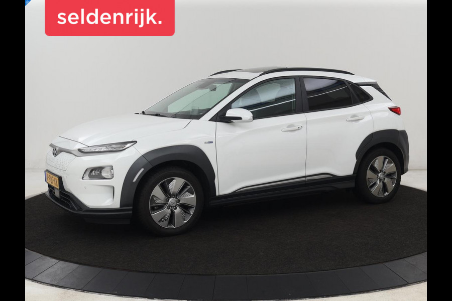 Hyundai Kona EV Limited 64 kWh | Schuifdak | Leder | Trekhaak | Stoelventilatie | Head-Up | Carplay | Warmtepomp | Achterbankverwarming | Navigatie | Camera | Full LED | Keyless