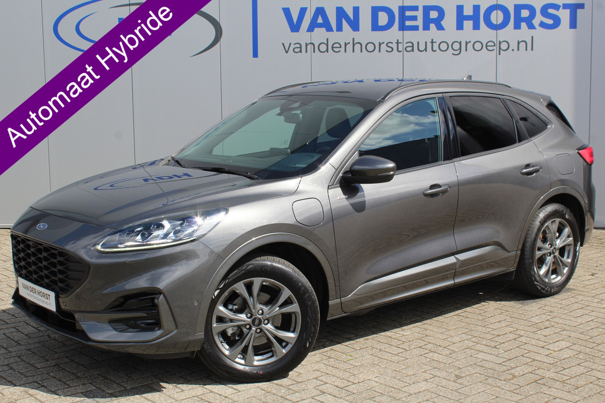 Ford Kuga 2.5-225pk Plug-in Hybrid ST-Line X. Hybride rijden voor een reële prijs ! Autm. airco dual, side- en lane assist, adaptieve cruise cntrl, camera v+a, stoel- en voorraamverw., elektr. achterklep, metallic lak, navigatie, telefoonvoorb.