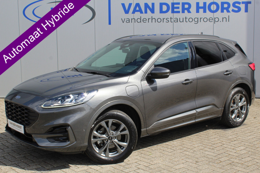 Ford Kuga 2.5-225pk Plug-in Hybrid ST-Line X. Hybride rijden voor een reële prijs ! Autm. airco dual, side- en lane assist, adaptieve cruise cntrl, camera v+a, stoel- en voorraamverw., elektr. achterklep, metallic lak, navigatie, telefoonvoorb.