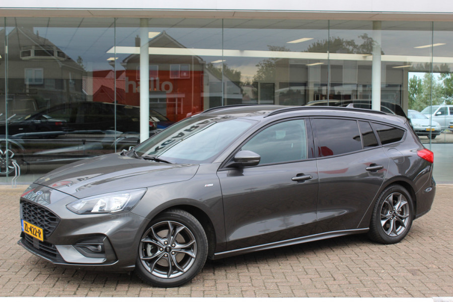 Ford FOCUS Wagon 1.0-125pk EcoBoost ST-Line AUTOMAAT ! Heel erg nette en goed onderhouden Ford Focus ST-Line wagon automaat. Volautm. airco dual, stoel-, stuur- en voorraamverw., camera, trekhaak, navigatie, telefoonvoorb., LM wln, cruise cntrl, skiluik etc., etc....