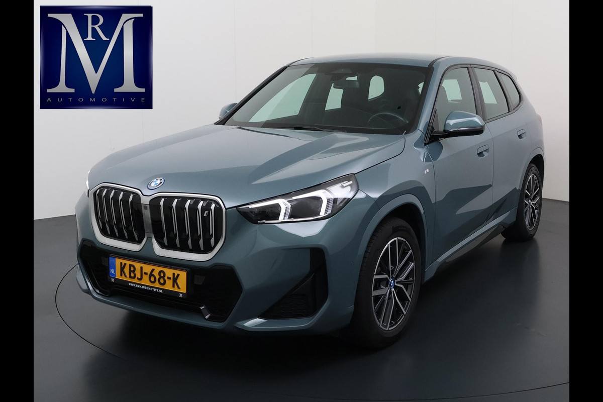 BMW iX1 xDrive30 67 kWh VAN € 41.900,- VOOR € 38.440,- UW LENTEVOORDEEL: € 3.460,-!| M-SPORT| COMPLEET | SOH 99% | ELEK. ACHTERKLEP |STOELVERWARMING| ACHTERUITRIJCAMERA| COMFORT ACCESS| APPLE CARPLAY/ ANDROID AUTO|