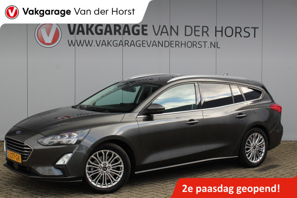 Ford FOCUS Wagon 1.0-125pk EcoBoost Titanium Business. Uiterst nette, comfortabele en ruime stationcar. Stoel-, stuur- en voorraamverw., Trekhaak, B&O soundsyst, lane assist, adaptieve cruise cntrl, camera a, LM wln, navigatie, telefoonvoorb. etc