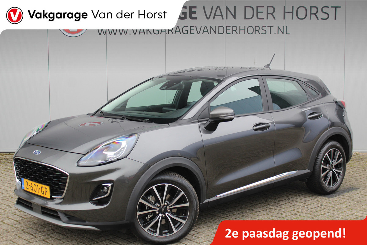 Ford Puma 1.0-125pk EcoBoost Mild-Hybrid Titanium. Fabrieksgarantie t/m 21-05-2027 ! Slechts 14.800km ! Volautm. airco, pdc achter, all season banden, stoel-, stuur- en voorraamverw., navigatie, telefoonvoorb., elektr. achterklep, cruise cntrl, keyless entry&go etc.