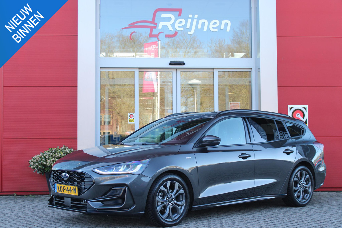 Ford FOCUS Wagon 1.0 155PK AUTOMAAT Hybrid ST LINE | ALL SEASON BANDEN | NAVIGATIE | DRAADLOZE APPLE CARPLAY/ANDROID AUTO | ADAPTIVE CRUISE CONTROL | LANE ASSIST | DODEHOEK DETECTIE | PARKEERSENSOREN VOOR + ACHTER | ACHTERUITRIJ CAMERA | LICHTMETALEN VELGEN 17" | DAB+ RADIO |