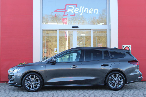 Ford FOCUS Wagon 1.0 155PK AUTOMAAT Hybrid ST LINE | ALL SEASON BANDEN | NAVIGATIE | DRAADLOZE APPLE CARPLAY/ANDROID AUTO | ADAPTIVE CRUISE CONTROL | LANE ASSIST | DODEHOEK DETECTIE | PARKEERSENSOREN VOOR + ACHTER | ACHTERUITRIJ CAMERA | LICHTMETALEN VELGEN 17" | DAB+ RADIO |