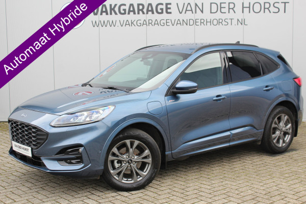 Ford Kuga 2.5-225 pk PHEV ST-Line X. Hybride rijden voor een reëel bedrag ! Slechts 31.500km ! Stoel-, stuur-, achterbank en voorraamverw., B&O soundsyst., Adaptieve Cruise Control, Climate Control dual, Camera v+a, Navigatie, Telefoonvoorb., Side- en lane assist etc.