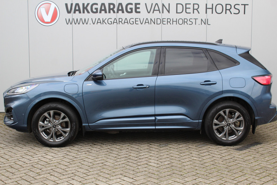 Ford Kuga 2.5-225 pk PHEV ST-Line X. Hybride rijden voor een reëel bedrag ! Slechts 31.500km ! Stoel-, stuur-, achterbank en voorraamverw., B&O soundsyst., Adaptieve Cruise Control, Climate Control dual, Camera v+a, Navigatie, Telefoonvoorb., Side- en lane assist etc.