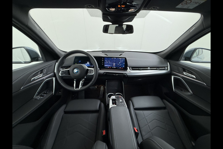 BMW iX1 eDrive20 67kWh M Sport pakket Pano-Dak/Schuif-dak Leer SOH 100% Warmtepomp Camera Navi Ecc PDC-a+v Apple Carplay Android Auto Elek.Achterklep Zwarte-Hemel VerkeersbordHerkenning WiFi M Aerodynamica  Lmv Led Privacy Glas Isofix DAB Keyless Wifi 1e Eigenaar Origineel Nederlandse Auto !!