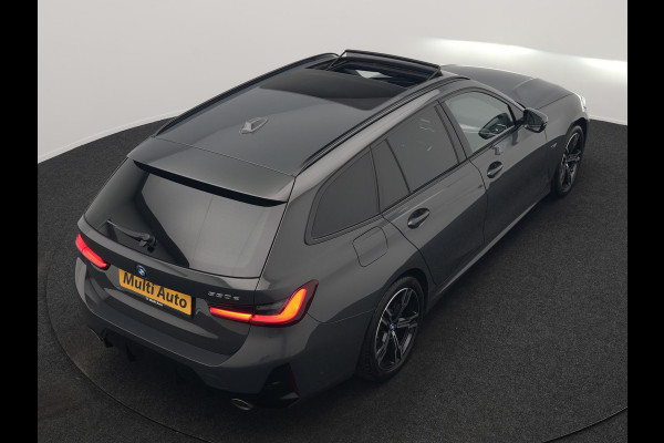 BMW 3 Serie Touring 330e M Sport FACELIFT PHEV 293pk Dealer O.H. | Trekhaak Af Fabriek | Panodak | Head Up | Camera | Dravitgrau | Lederen Sportstoelen Verwarmd | Sfeerverlichting | Apple Carplay | Keyless | Blis | Cruise Control | Navigatie | DAB | Plug In Hybrid |