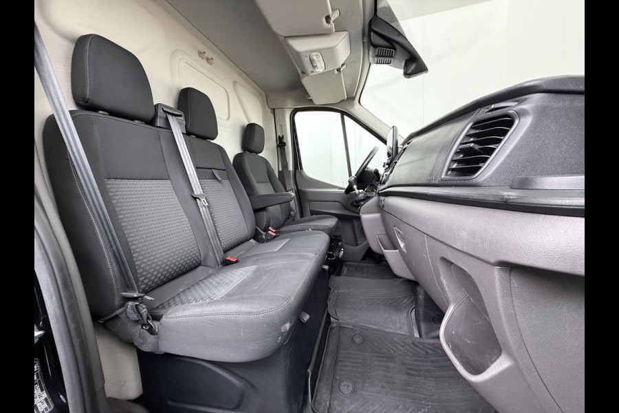 Ford Transit 310 2.0 TDCI L2H2 3-Persoons Camera Airco Stoelverwarming Elek.Stoel Cruise Control Pdc Lane Assist Trend Betonplex Vloer Wandbetimmering Schuifdeur Voorruitverwarming 1e Eigenaar Origineel Nederlandse Bus