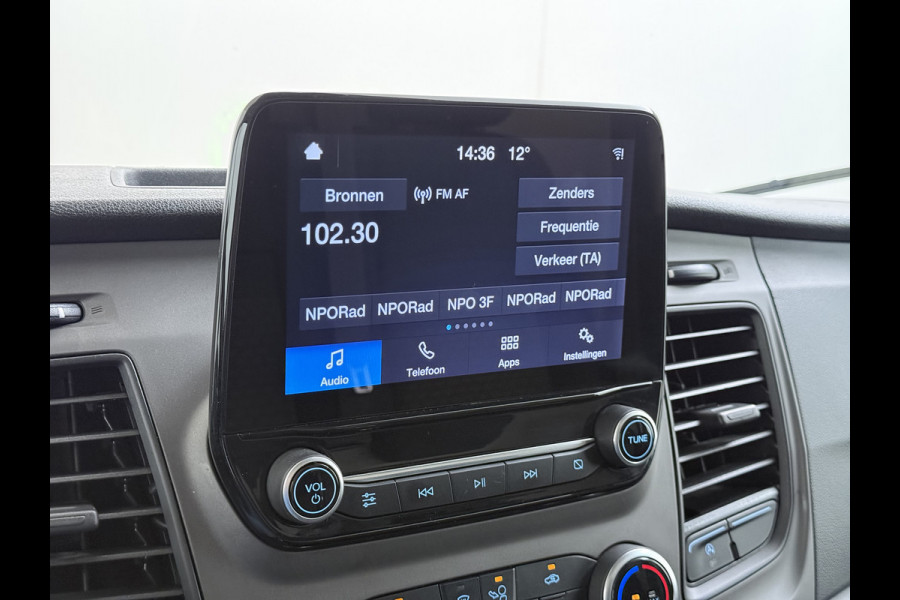 Ford Transit 310 2.0 TDCI L2H2 3-Persoons Camera Airco Stoelverwarming Elek.Stoel Cruise Control Pdc Lane Assist Trend Betonplex Vloer Wandbetimmering Schuifdeur Voorruitverwarming 1e Eigenaar Origineel Nederlandse Bus
