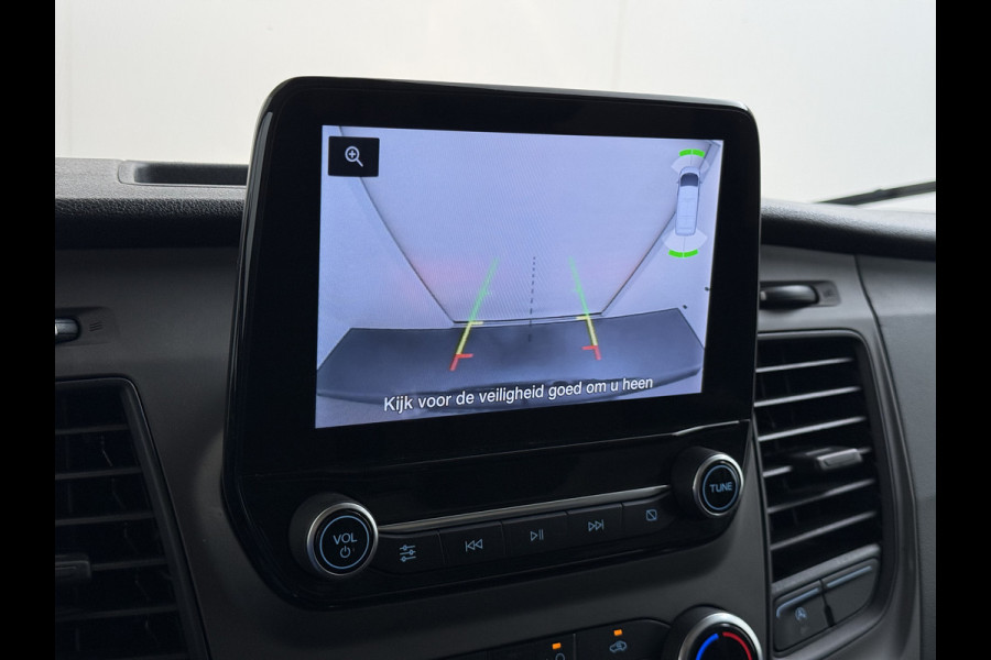 Ford Transit 310 2.0 TDCI L2H2 3-Persoons Camera Airco Stoelverwarming Elek.Stoel Cruise Control Pdc Lane Assist Trend Betonplex Vloer Wandbetimmering Schuifdeur Voorruitverwarming 1e Eigenaar Origineel Nederlandse Bus