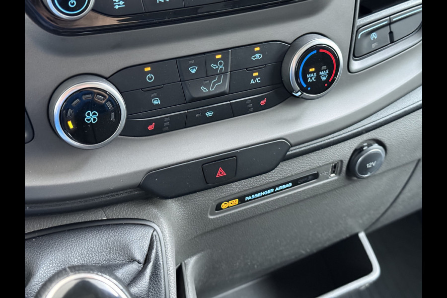 Ford Transit 310 2.0 TDCI L2H2 3-Persoons Camera Airco Stoelverwarming Elek.Stoel Cruise Control Pdc Lane Assist Trend Betonplex Vloer Wandbetimmering Schuifdeur Voorruitverwarming 1e Eigenaar Origineel Nederlandse Bus