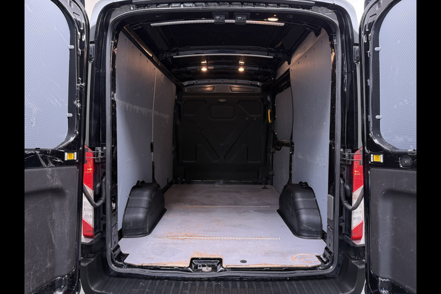 Ford Transit 310 2.0 TDCI L2H2 3-Persoons Camera Airco Stoelverwarming Elek.Stoel Cruise Control Pdc Lane Assist Trend Betonplex Vloer Wandbetimmering Schuifdeur Voorruitverwarming 1e Eigenaar Origineel Nederlandse Bus