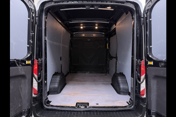Ford Transit 310 2.0 TDCI L2H2 3-Persoons Camera Airco Stoelverwarming Elek.Stoel Cruise Control Pdc Lane Assist Trend Betonplex Vloer Wandbetimmering Schuifdeur Voorruitverwarming 1e Eigenaar Origineel Nederlandse Bus