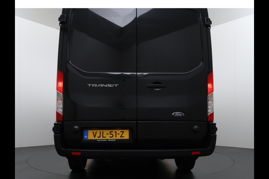 Ford Transit 310 2.0 TDCI L2H2 3-Persoons Camera Airco Stoelverwarming Elek.Stoel Cruise Control Pdc Lane Assist Trend Betonplex Vloer Wandbetimmering Schuifdeur Voorruitverwarming 1e Eigenaar Origineel Nederlandse Bus