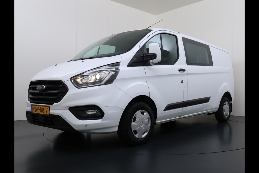 Ford Transit Custom 300 2.0TDCI 130PK Dubbele Cabine L2H1 Trekhaak Navi Camera Airco Cruise Control Pdc Trend DC Schuifdeur Betonplex Vloer Wandbetimmering Bott Inbouwkast Lane Assist 2.800KG Trekgewicht 1e Eigenaar