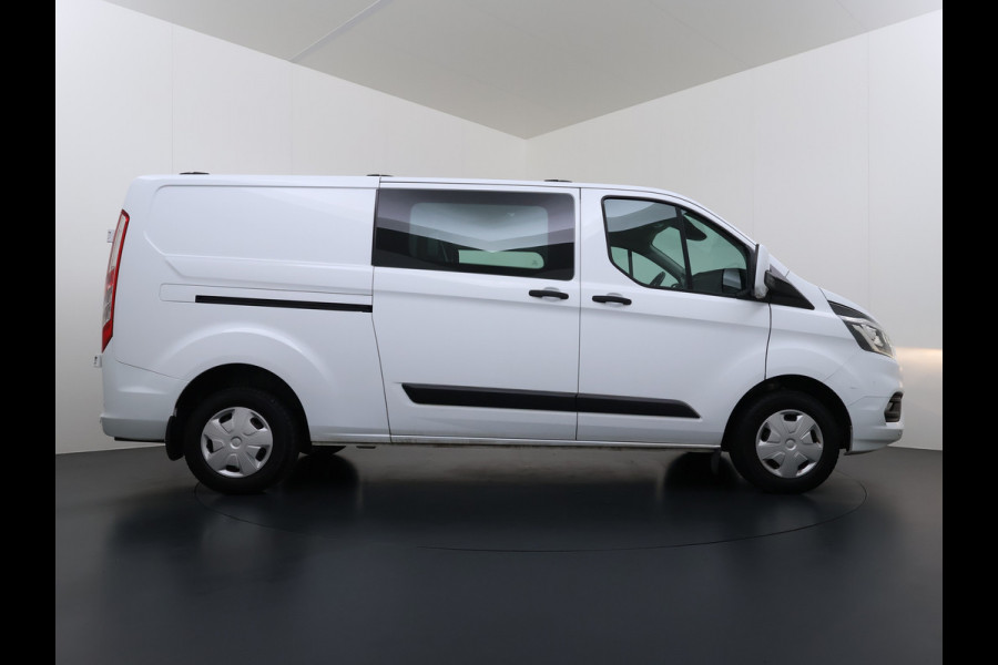 Ford Transit Custom 300 2.0TDCI 130PK Dubbele Cabine L2H1 Trekhaak Navi Camera Airco Cruise Control Pdc Trend DC Schuifdeur Betonplex Vloer Wandbetimmering Bott Inbouwkast Lane Assist 2.800KG Trekgewicht 1e Eigenaar
