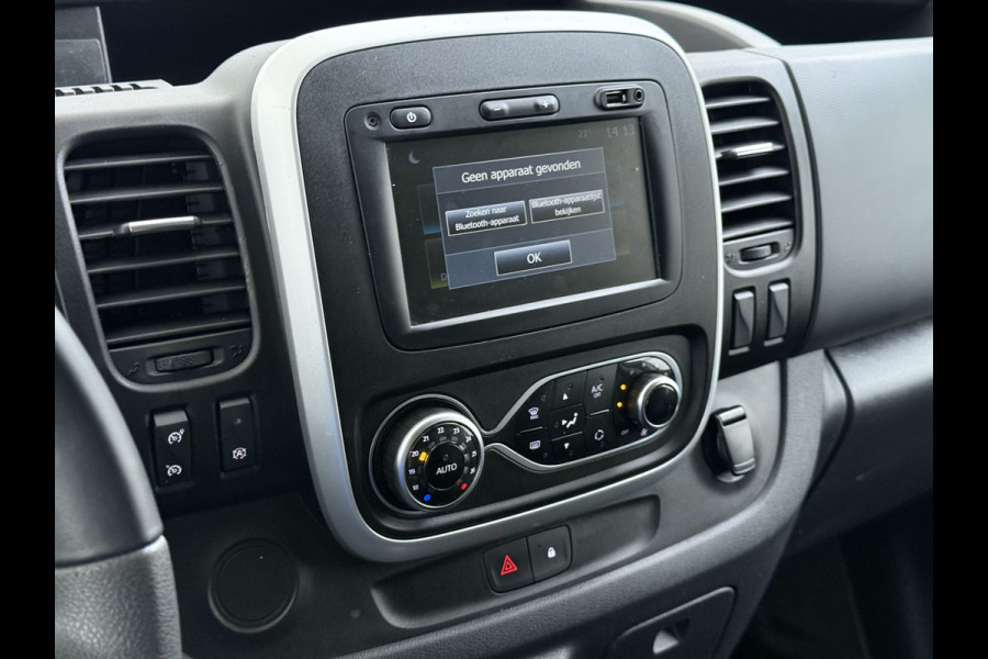 Renault Trafic 2.0 dCi 120 T29 L2H1 Dubbele Cabine Trekhaak Camera Navi Ecc Cruise Control Pdc DAB Business Euro 6 Betonplex Vloer Wandbetimmering Regen-Lichtsensor 2.000kg Trekgewicht 1e Eigenaar 5-Persoons