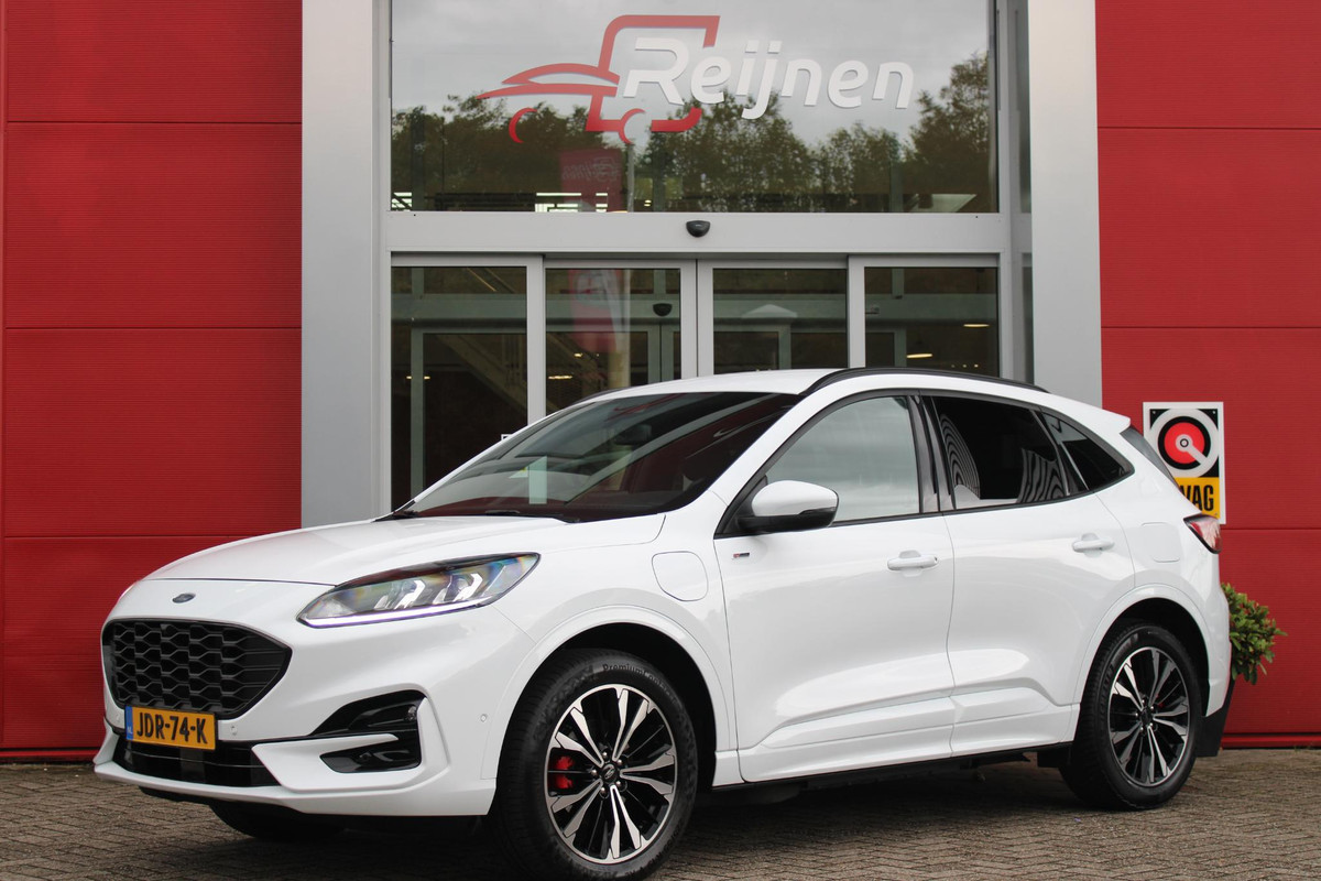Ford Kuga 2.5 PHEV 225PK ST-LINE X | ELEKTRISCH WEGKLAPBARE TREKHAAK | NAVIGATIE | WINTER PACK: VOORRUIT/STUUR/STOEL VERWARMING | ACHTERBANK VERWARMING | DODEHOEKDETECTIE | CAMERA VOOR + ACHTER | KEYLESS ENTRY/START | RODE REMKLAUWEN | ADAPTIVE CRUISE CONTROL | DAB+ RADIO | APPLE CARPLAY/ANDROID AUTO | 19" LICHTMETALEN VELGEN | PARKEERSENSOREN VOOR + ACHTER | AUTOMATISCH INPARKEREN | ELEKTRISCH BEDIENBARE ACHTERKLEP |
