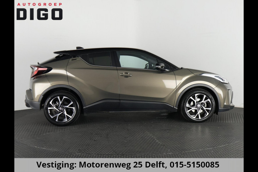 Toyota C-HR 1.8 HYBRID BI-TONE LUXERY LINE GARANTIE 5-2032 TREKHAAK. 4 SEIZOENEN BANDEN.NAVIGATIE. STUUR EN STOELVERWARMING. HALF LEDER
