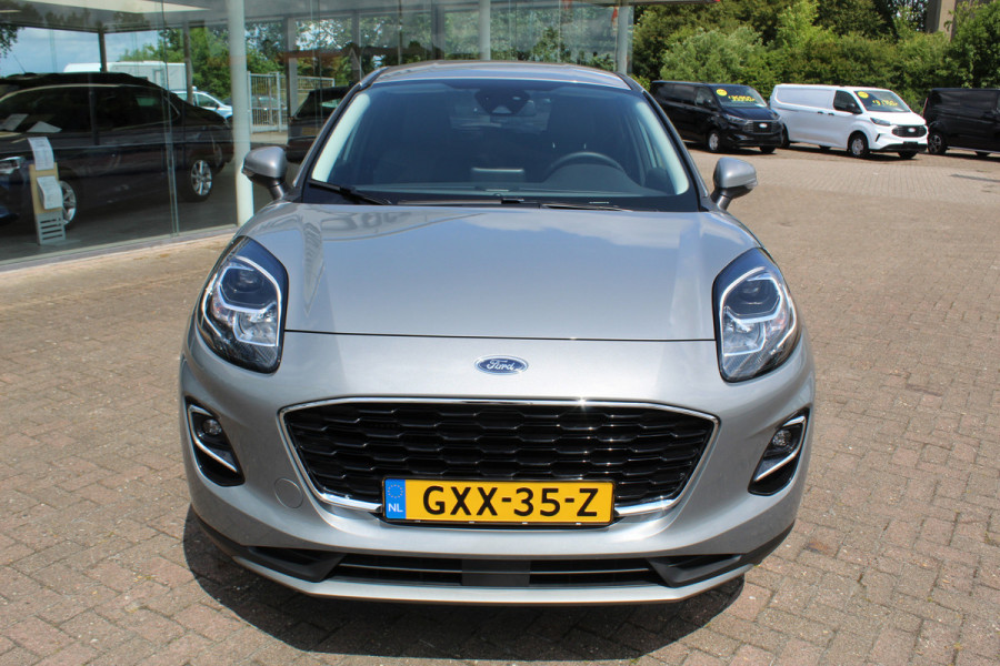 Ford Puma 1.0-125pk EcoBoost Mild-Hybrid Titanium X. Garantie t/m 07-03-2028 ! Slechts 7.400km ! Cruise cntrl, climate cntrl, stoel-, stuur- en voorraamverw., draadloos opladen telefoon, trekhaak afneembaar, navigatie, telefoonvoorb., LM wielen, B&O soundsyst., digitaal dashboard etc.