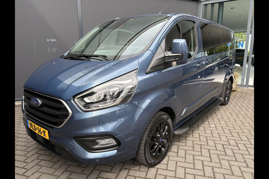 Ford Transit Custom 320 2.0 TDCI L2H1 Platinum Edition DC Automaat Achteruitrijcamera - Parkeersensoren - Navigatie - Airco - Dodehoek detector - Cruise control - Licht metalen velgen 16 inch - Lederen bekleding - Radio - Bluetooth - Dubbele cabine - Tussens - Mistlampen voor - Sidebars - Trekhaak - Voorstoelen verwarmd - Led verlichting - Extra getint glas achter - Start/stop systeem - Stuur multifunctioneel - Stuur leder - Regensensor