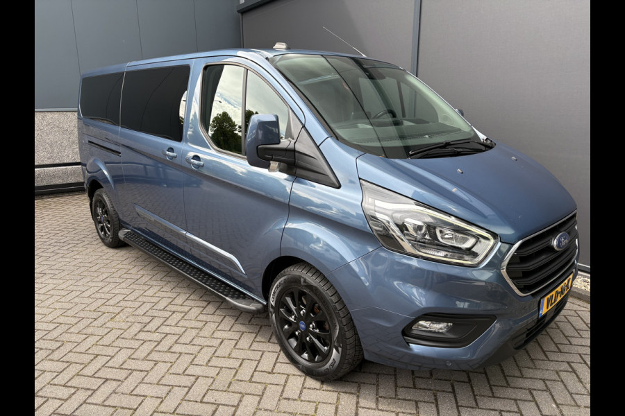 Ford Transit Custom 320 2.0 TDCI L2H1 Platinum Edition DC Automaat Achteruitrijcamera - Parkeersensoren - Navigatie - Airco - Dodehoek detector - Cruise control - Licht metalen velgen 16 inch - Lederen bekleding - Radio - Bluetooth - Dubbele cabine - Tussens - Mistlampen voor - Sidebars - Trekhaak - Voorstoelen verwarmd - Led verlichting - Extra getint glas achter - Start/stop systeem - Stuur multifunctioneel - Stuur leder - Regensensor